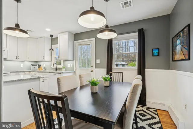 a view of a dining room with furniture wooden floor and chandelier
