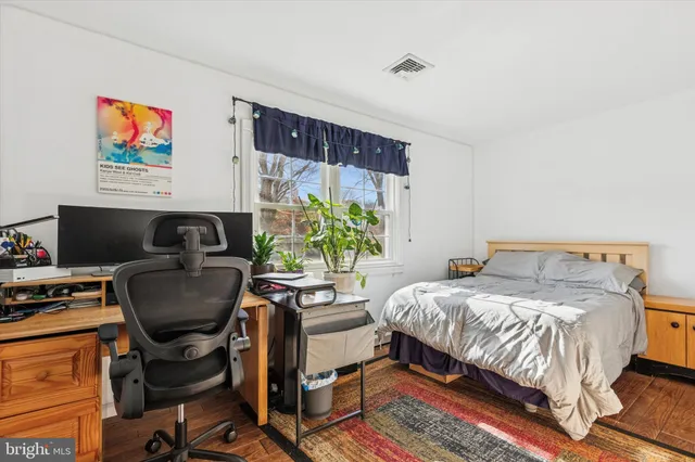 a bedroom with a bed and a couch