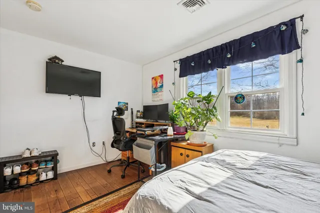 a bedroom with a workspace