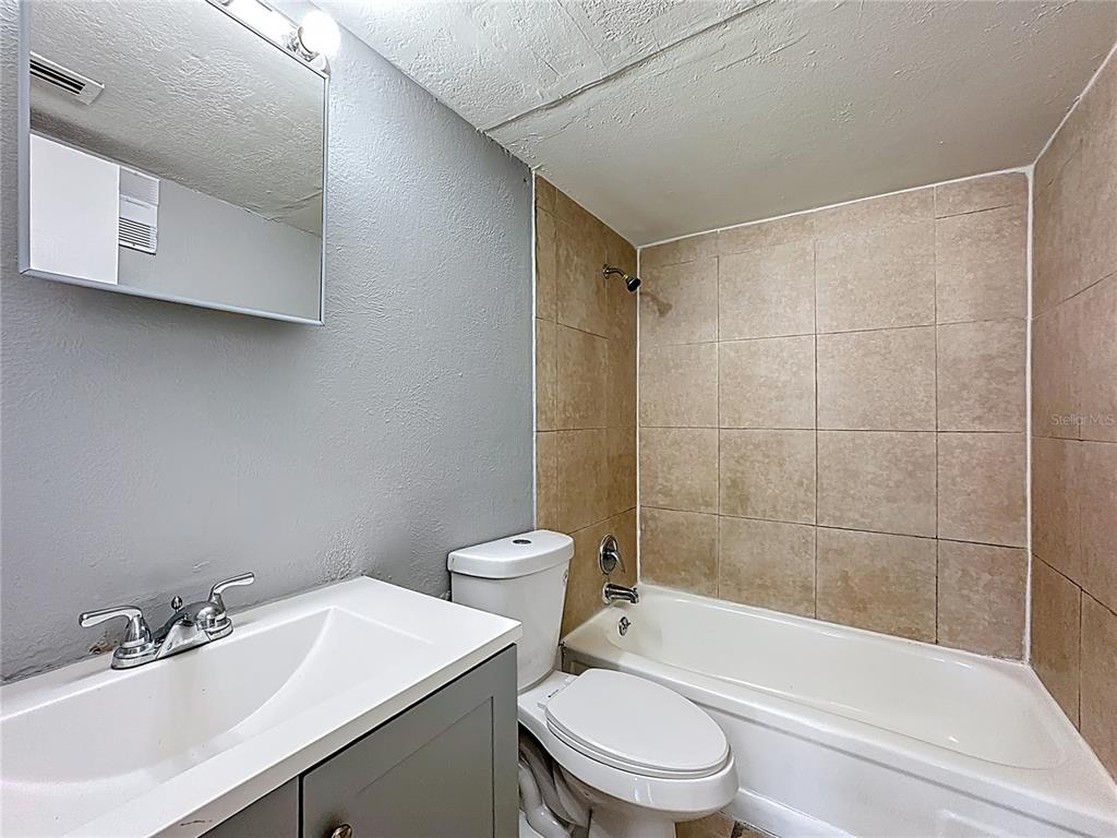 2753 L B McLeod Road, Unit D Orlando, FL 32805 - Photo 22 of 48 a bathroom with a sink toilet and shower