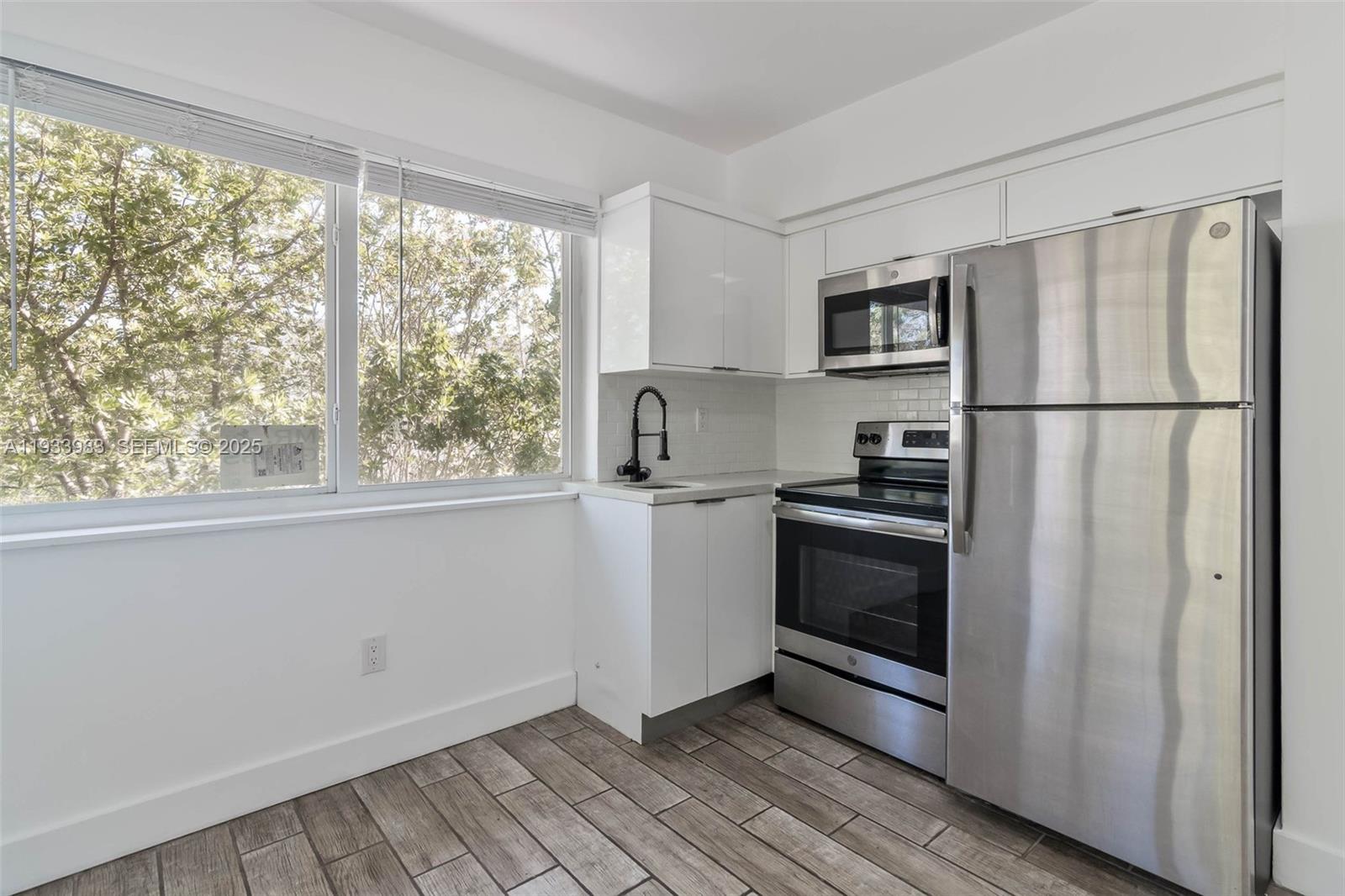 a kitchen with a refrigerator and a stove