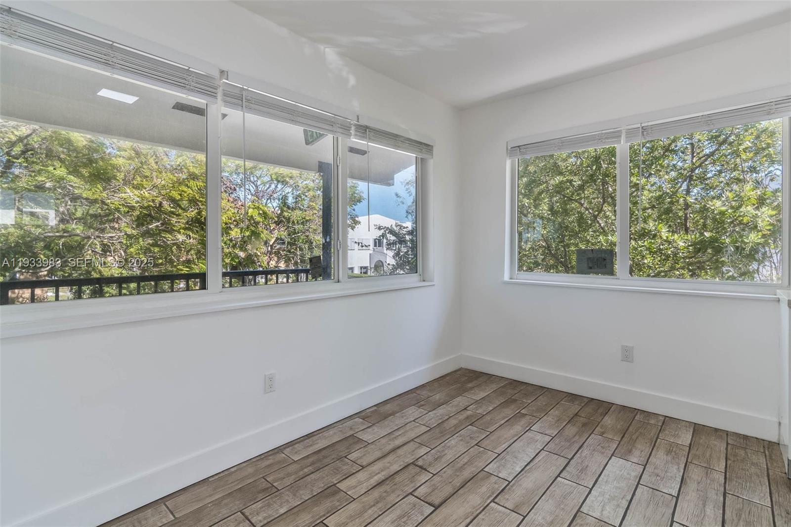 2190 Southwest 14th Terrace, Unit 6 Miami, FL 33145 - Photo 6 of 11 a view of a room with wooden floor and windows
