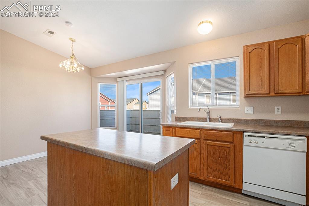 4822 Rusty Nail Point, Unit 201 Colorado Springs, CO 80916 - Photo 11 of 33 a kitchen with a sink a window and cabinets