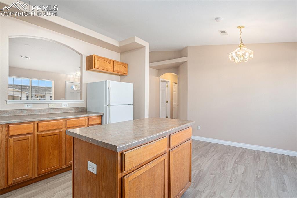 4822 Rusty Nail Point, Unit 201 Colorado Springs, CO 80916 - Photo 12 of 33 a kitchen with stainless steel appliances granite countertop a sink and a refrigerator
