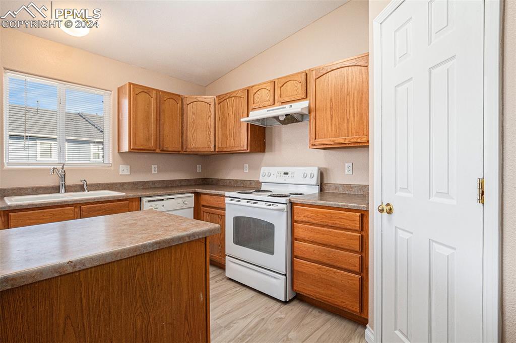 4822 Rusty Nail Point, Unit 201 Colorado Springs, CO 80916 - Photo 13 of 33 a kitchen with stainless steel appliances granite countertop a sink stove and a refrigerator