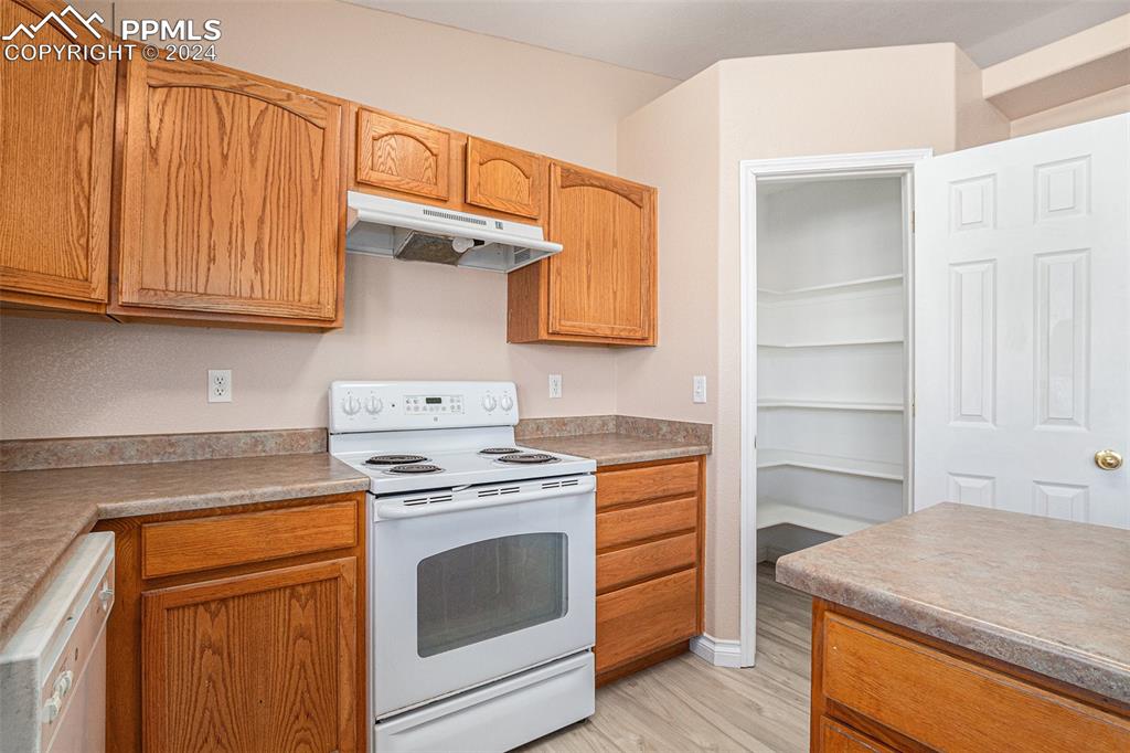 4822 Rusty Nail Point, Unit 201 Colorado Springs, CO 80916 - Photo 14 of 33 a kitchen with stainless steel appliances granite countertop a stove and a refrigerator