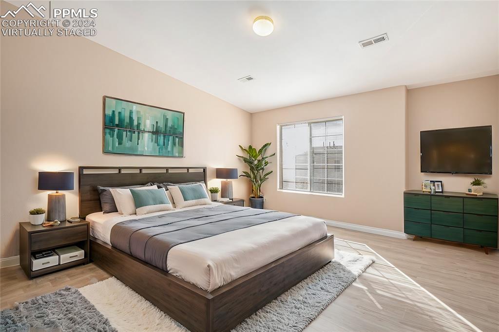 4822 Rusty Nail Point, Unit 201 Colorado Springs, CO 80916 - Photo 15 of 33 a bedroom with a bed and a flat screen tv