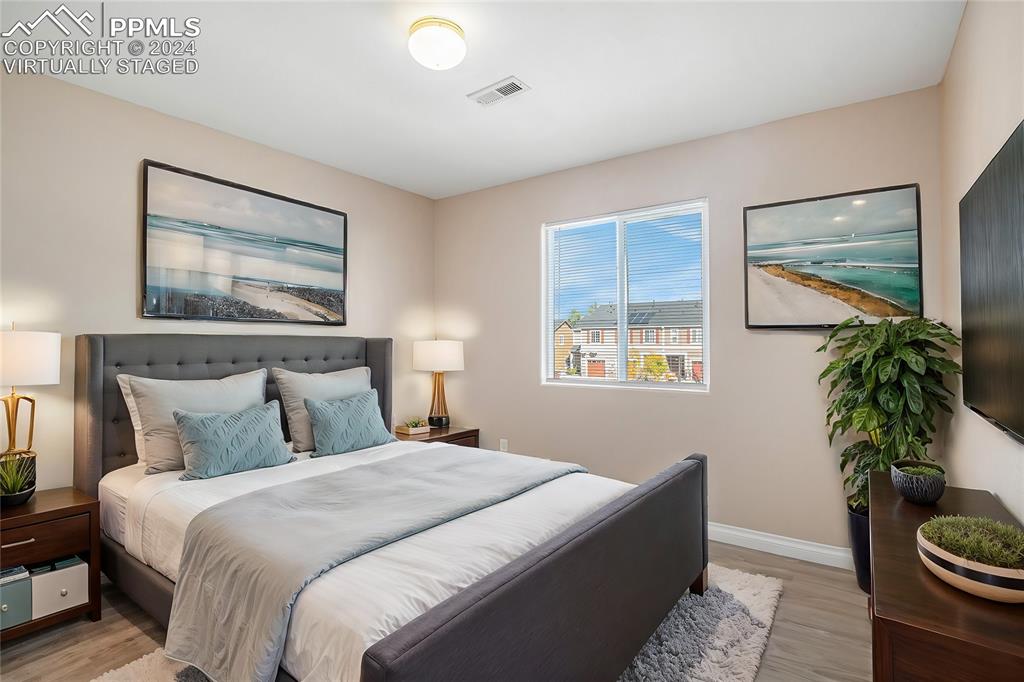 4822 Rusty Nail Point, Unit 201 Colorado Springs, CO 80916 - Photo 20 of 33 a bedroom with bed and a potted plant