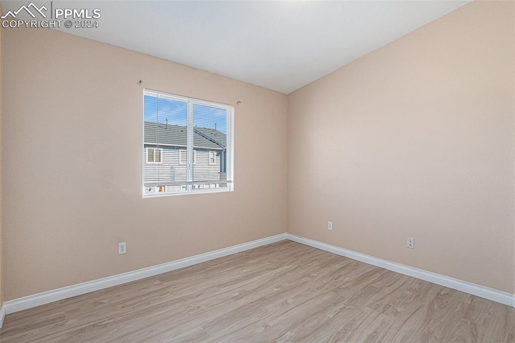 4822 Rusty Nail Point, Unit 201 Colorado Springs, CO 80916 - Photo 24 of 33 wooden floor in an empty room with a window