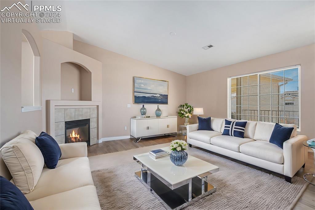 4822 Rusty Nail Point, Unit 201 Colorado Springs, CO 80916 - Photo 6 of 33 a living room with furniture and a fireplace