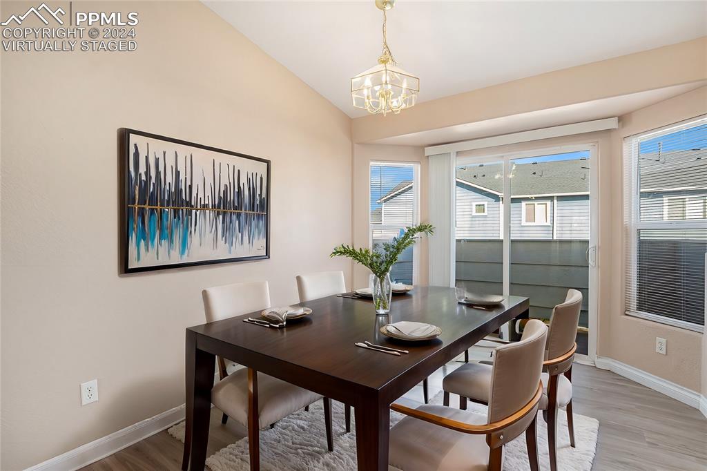 4822 Rusty Nail Point, Unit 201 Colorado Springs, CO 80916 - Photo 9 of 33 a view of a dining room with furniture window and wooden floor