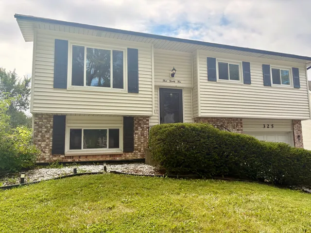 a view of a house with a yard and a large window