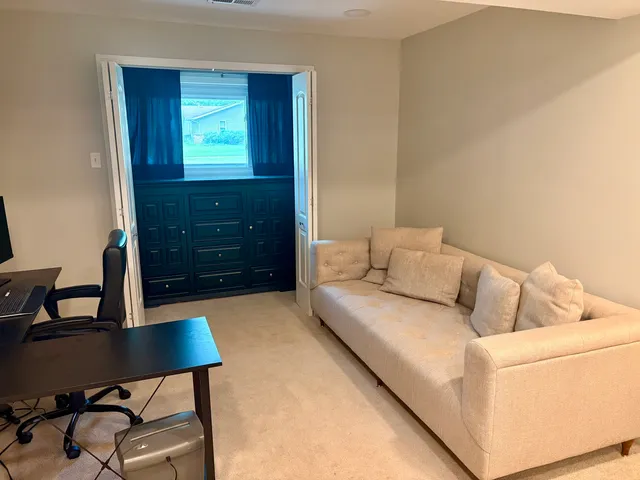 a living room with furniture and a window