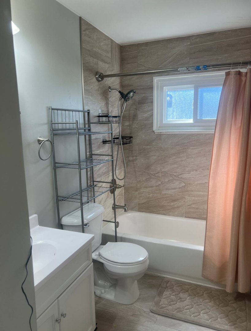 325 Rockhurst Road Bolingbrook, IL 60440 - Photo 8 of 17 a bathroom with a toilet a sink and a shower