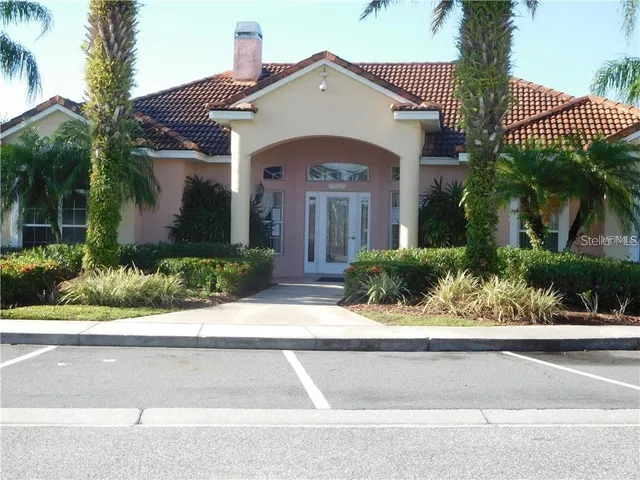 a view of back yard of the house with outdoor seating