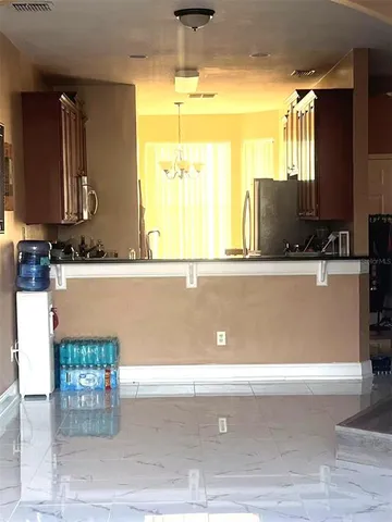 a view of a living room with a computer on a table and a large window