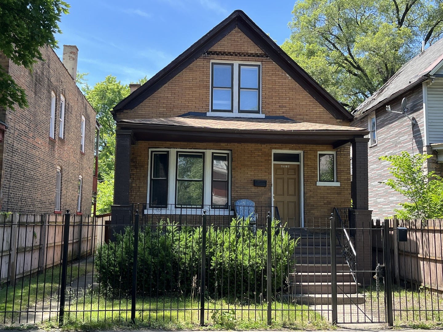 6916 South Lowe Avenue Chicago, IL 60621 - Photo 1 of 22 a front view of a house with a garden