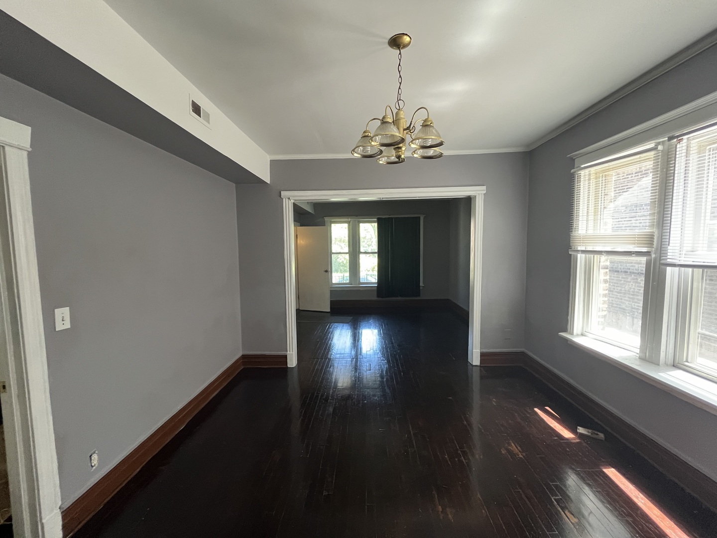 6916 South Lowe Avenue Chicago, IL 60621 - Photo 4 of 22 a view of empty room with wooden floor and fan