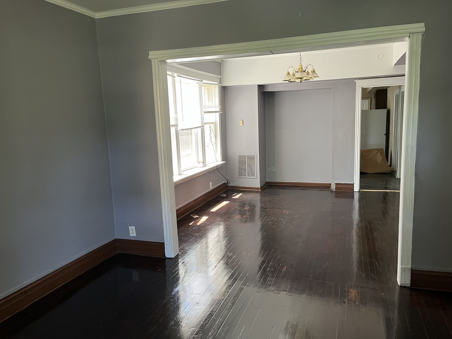 6916 South Lowe Avenue Chicago, IL 60621 - Photo 5 of 22 an empty room with wooden floor and windows