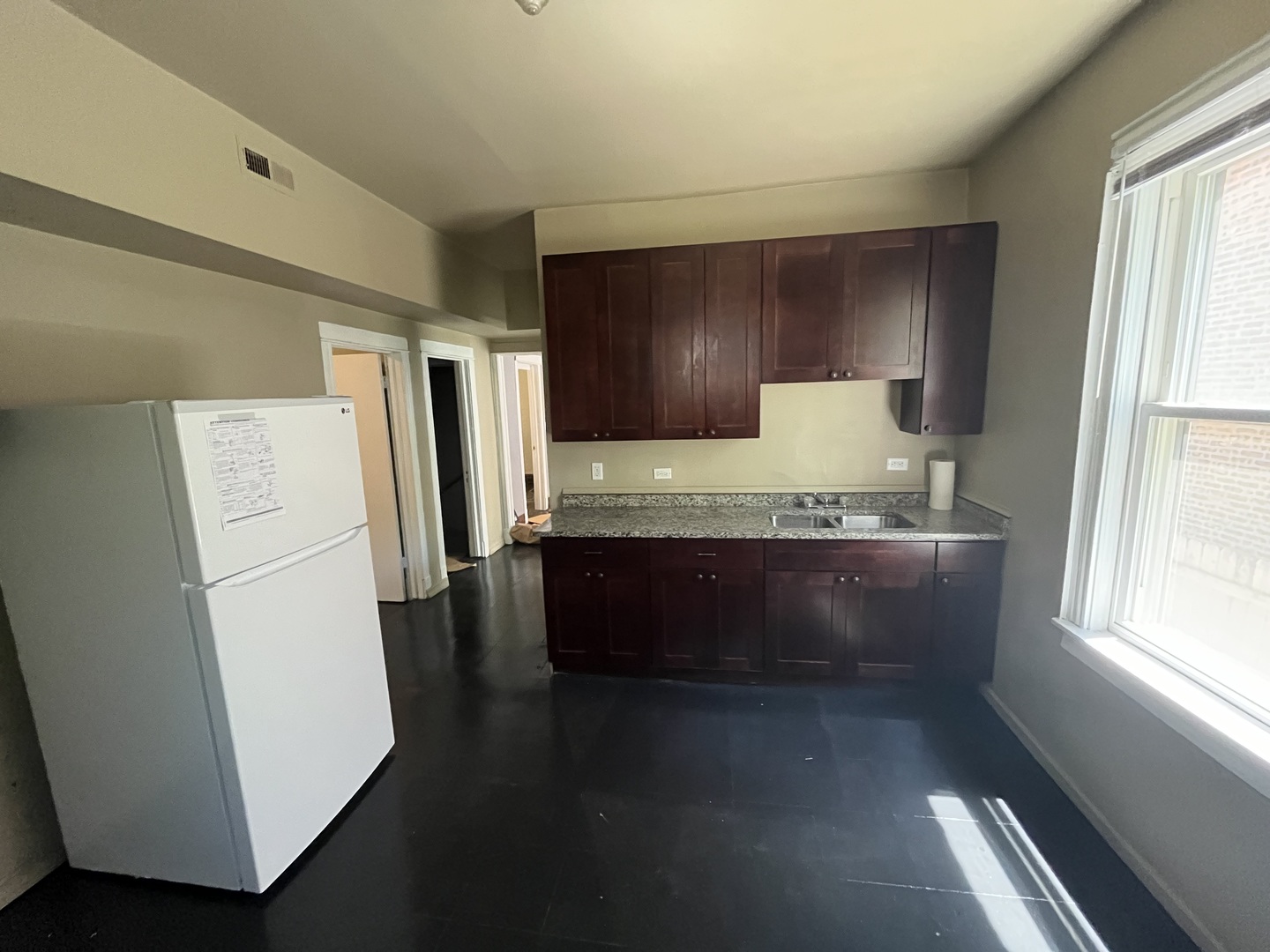 6916 South Lowe Avenue Chicago, IL 60621 - Photo 7 of 22 a view of kitchen with refrigerator and window