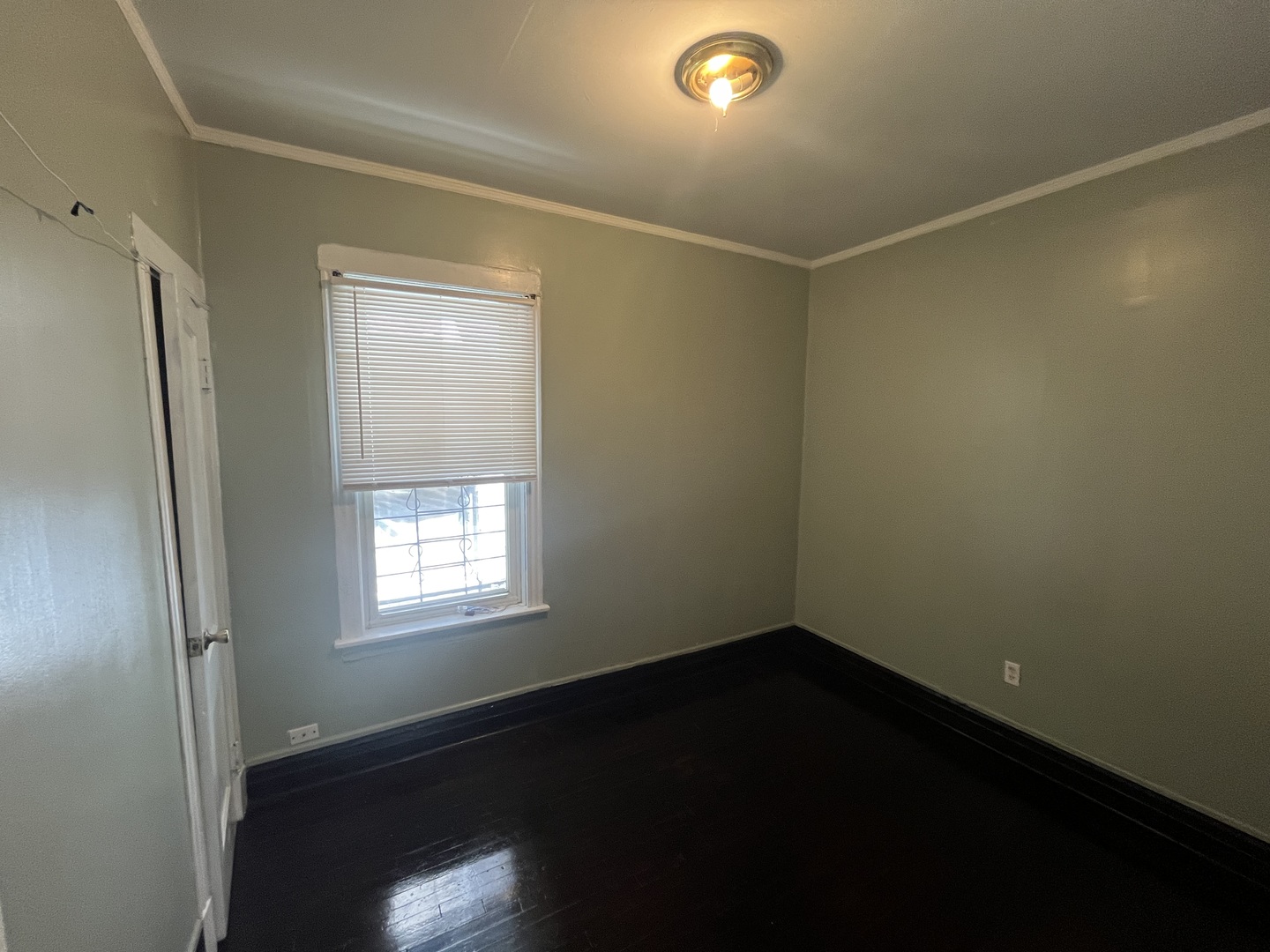 6916 South Lowe Avenue Chicago, IL 60621 - Photo 10 of 22 a view of an empty room with wooden floor and a window
