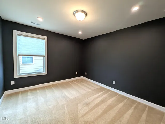 a view of an empty room and a window