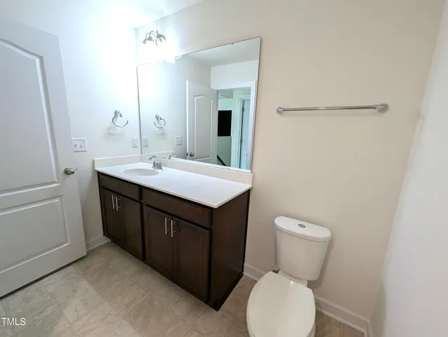a bathroom with a sink a toilet and mirror