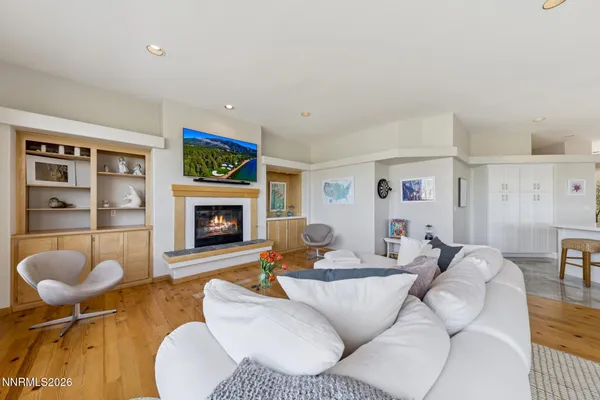 a large kitchen with a stove a refrigerator a sink a oven with a dining table and chairs