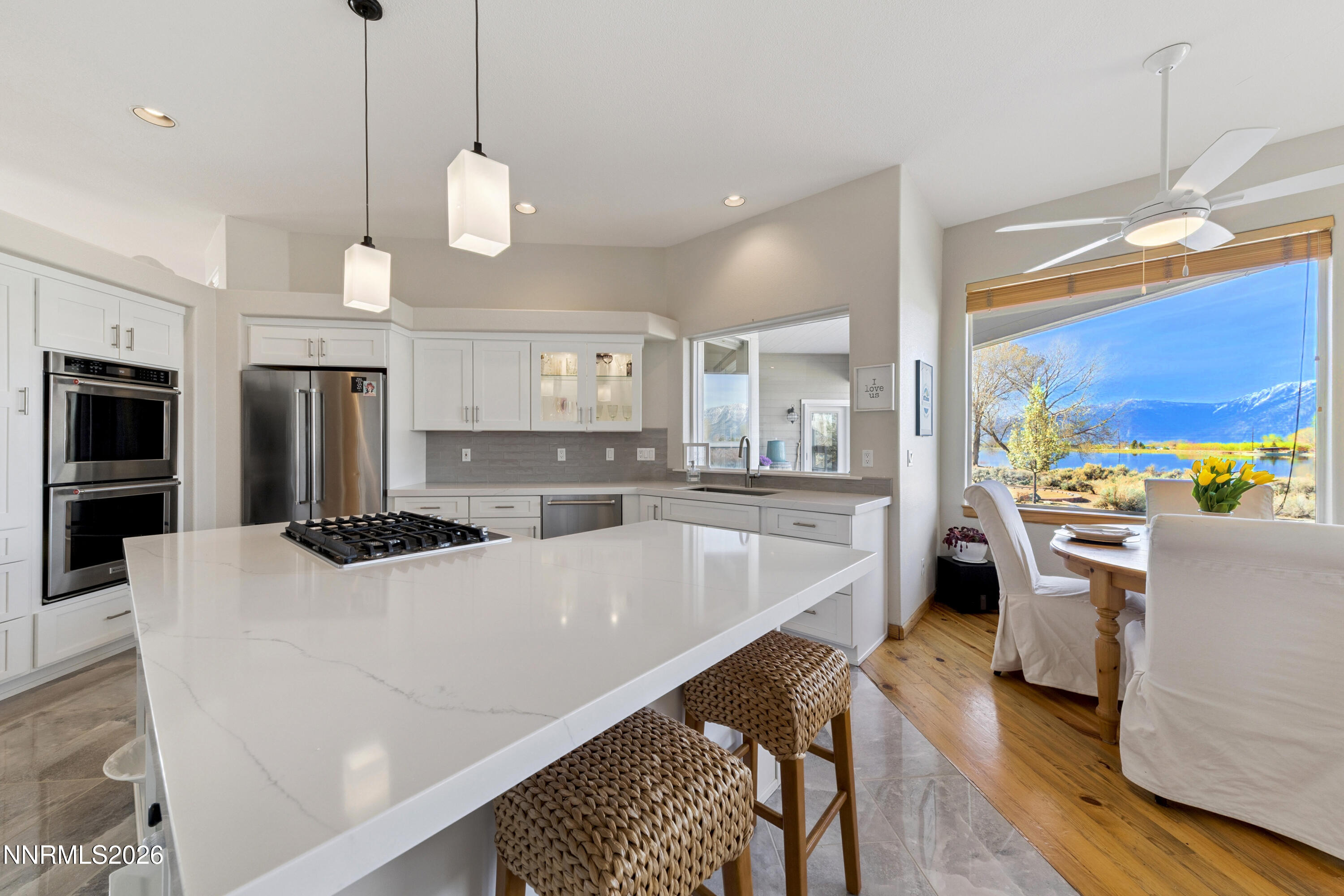 1608 East Valley Road Gardnerville, NV 89410 - Photo 15 of 54 a large kitchen with kitchen island white cabinets and stainless steel appliances