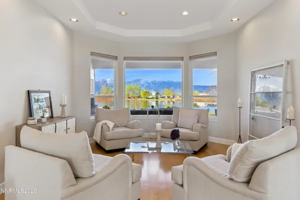 a living room with fireplace furniture and a large window