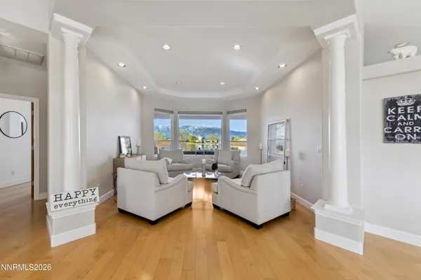 a living room with furniture a fireplace and a large window