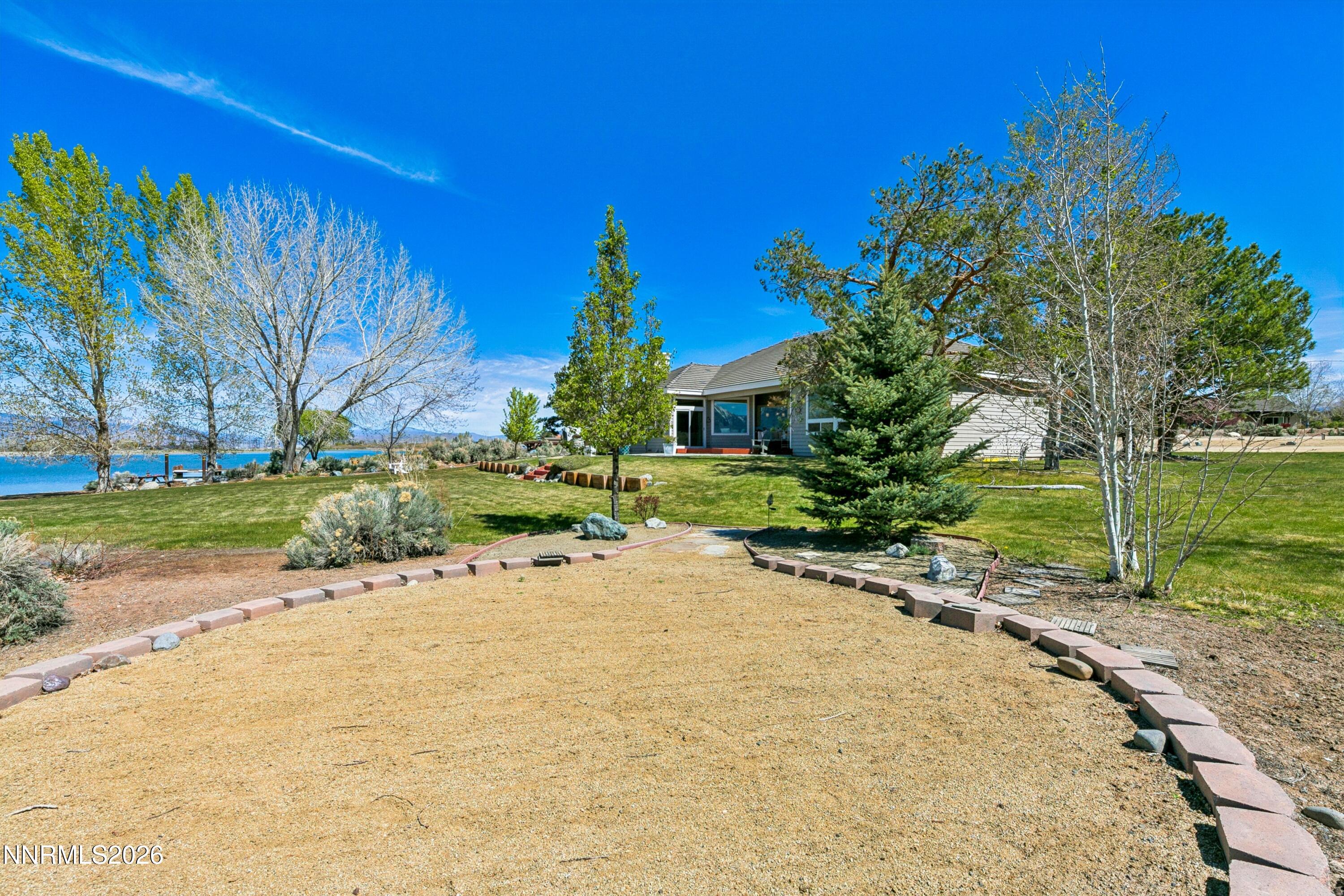 1608 East Valley Road Gardnerville, NV 89410 - Photo 52 of 54 a row of palm trees and a yard with tree in front of it