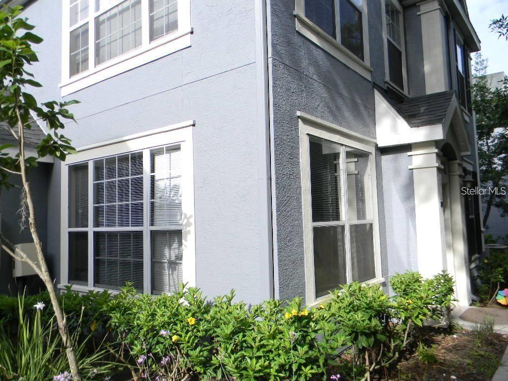 5521 Rosehill Road, Unit 103 Sarasota, FL 34233 - Photo 2 of 24 a view of a brick house with many windows and plants