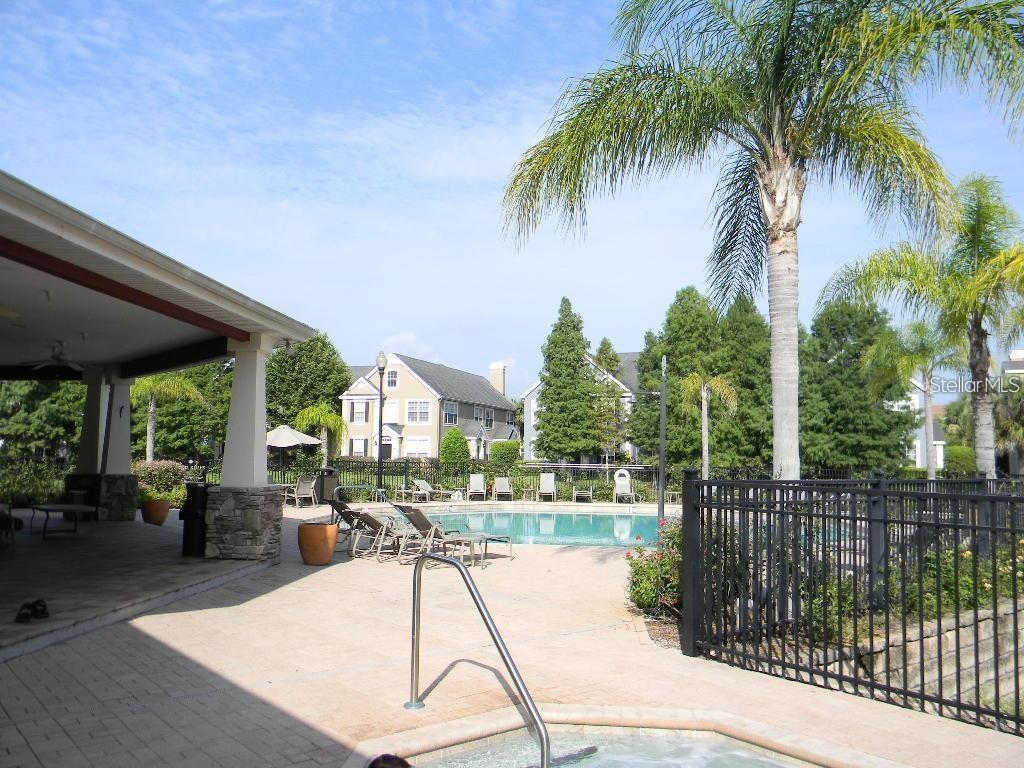 5521 Rosehill Road, Unit 103 Sarasota, FL 34233 - Photo 23 of 24 a swimming pool with outdoor seating and yard