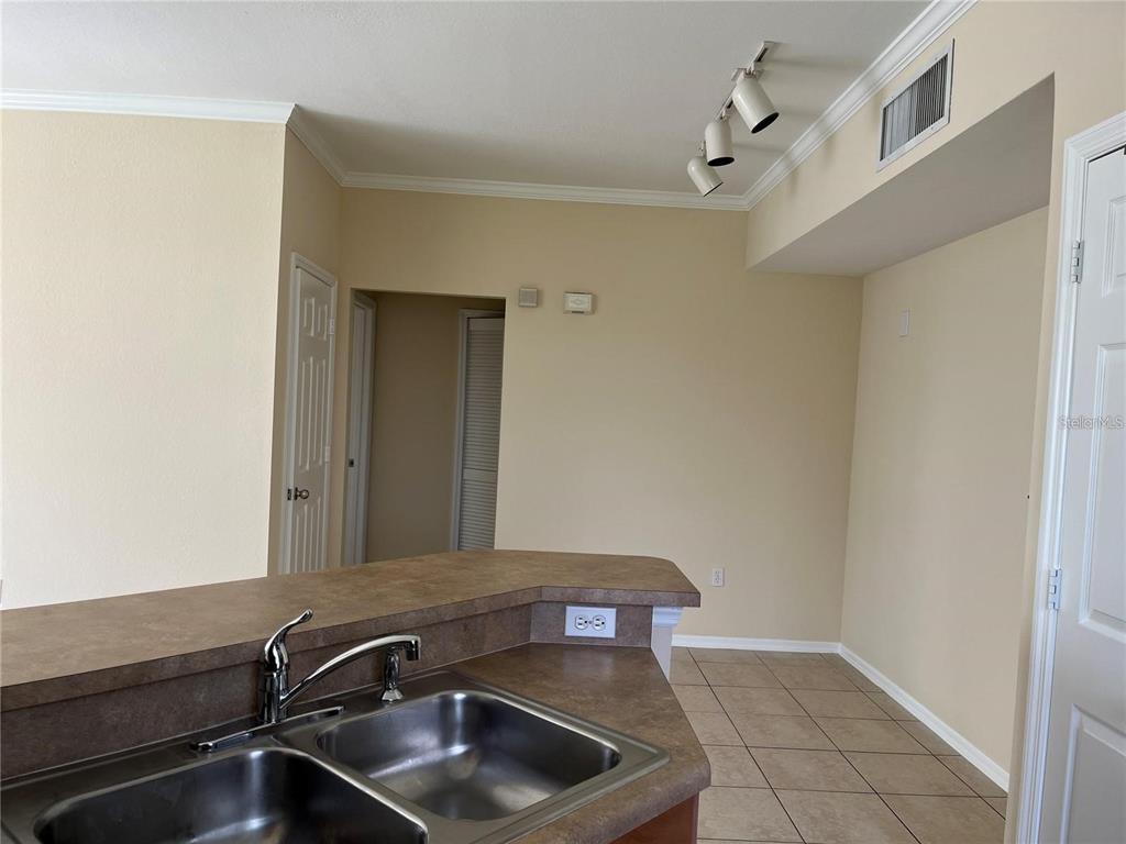5521 Rosehill Road, Unit 103 Sarasota, FL 34233 - Photo 7 of 24 a room with a sink and cabinets