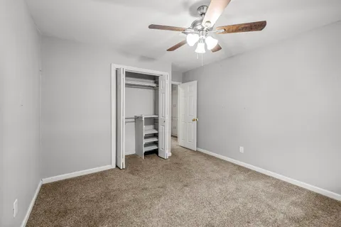 a view of an empty room with a ceiling fan