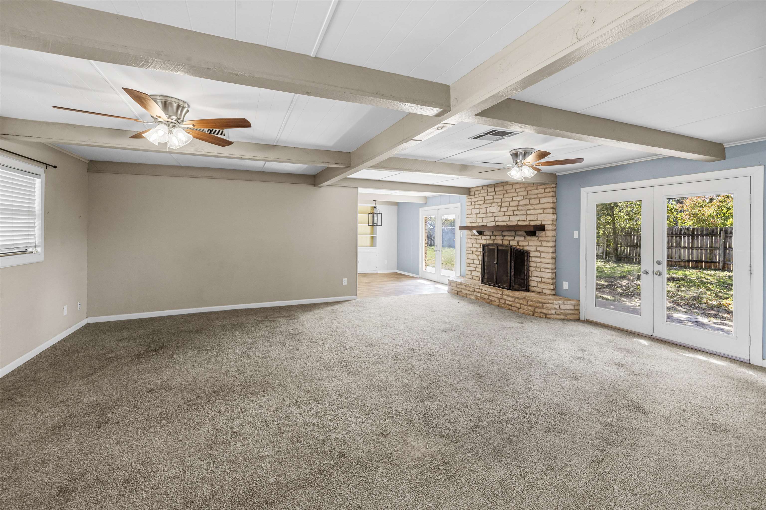 1401 Brazos Street Marble Falls, TX 78654 - Photo 4 of 23 an empty room with fireplace fan and windows