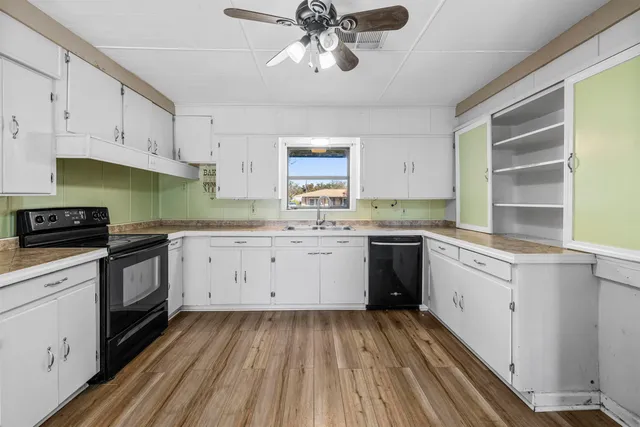 a kitchen with a sink window and cabinets