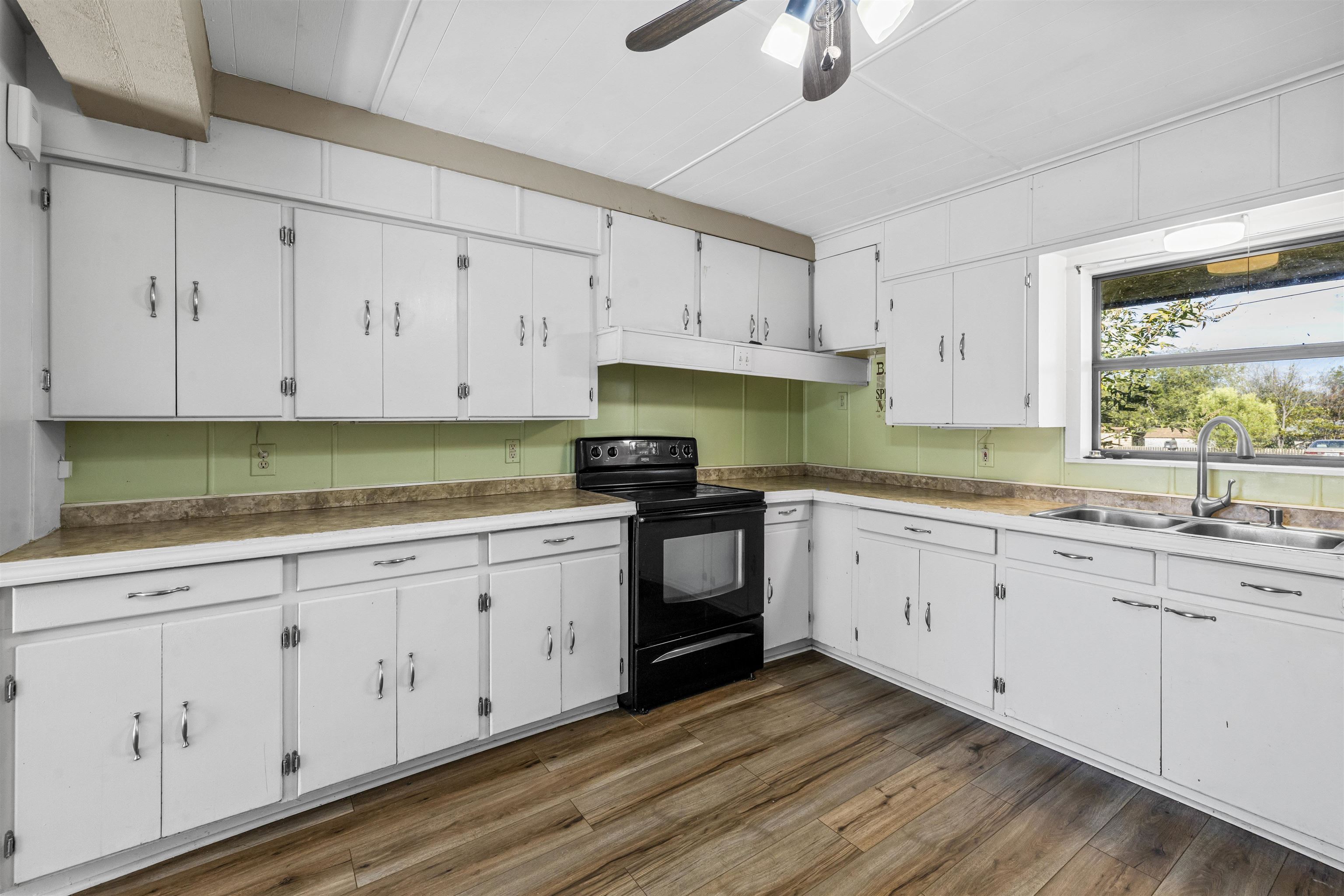 1401 Brazos Street Marble Falls, TX 78654 - Photo 6 of 23 a kitchen with granite countertop white cabinets white stainless steel appliances and a sink