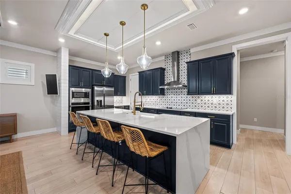 a large kitchen with stainless steel appliances lots of counter space a sink and cabinets