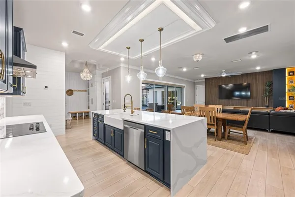 a kitchen with stainless steel appliances a stove a sink and a refrigerator