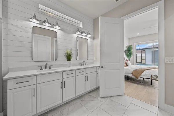 a bathroom with a shower sink vanity and mirror
