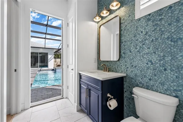 a bathroom with a sink a toilet and a mirror