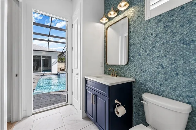 a bathroom with a sink a toilet and a mirror