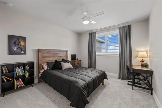 a bedroom with a bed a table and chair