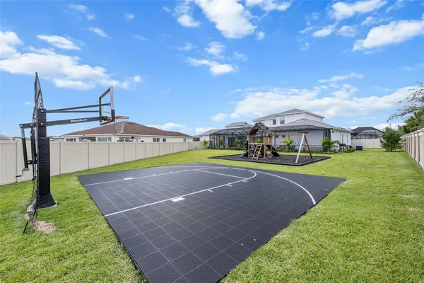 an aerial view of a house with a garden and lake view
