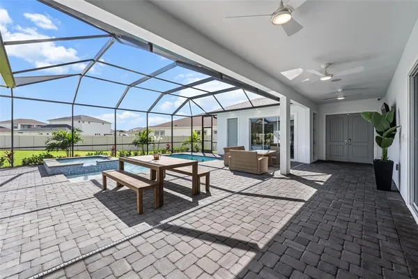a building outdoor space with patio furniture and potted plants