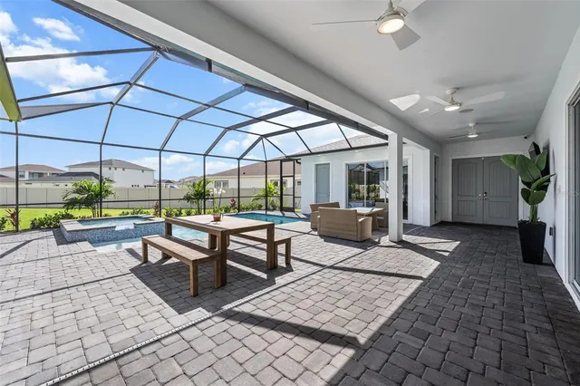 a building outdoor space with patio furniture and potted plants