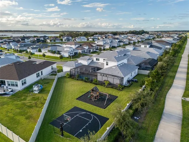 an aerial view of residential building with outdoor space and ocean view