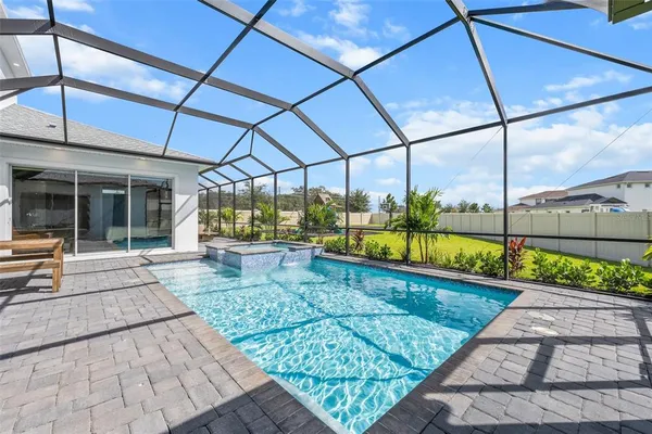 a view of a patio with table and chairs under an umbrella
